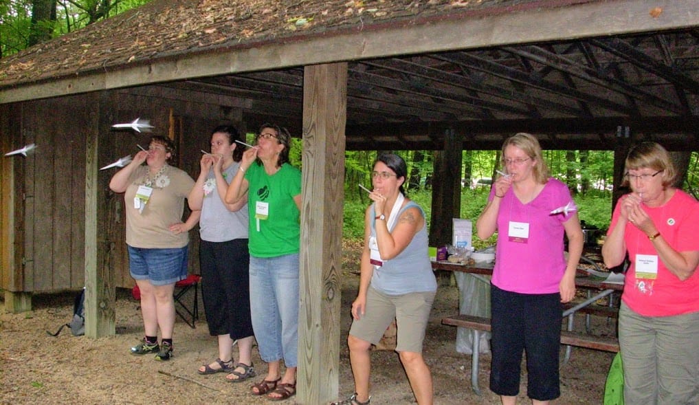 Women launching paper rockets