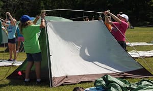 Girls putting up a tent