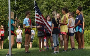 Girls performing a flag ceremony at Caddoodles