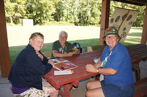 Three RVAA members smiling while at a picnic table