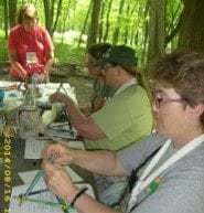 Girl Scout alumnae learning a STEM activity at camp